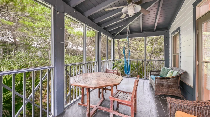 The Front Porch Has Seating, a Table, and a Hammock Chair