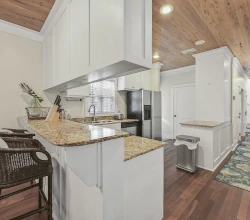 Seating at the Bar and Kitchen Viewed from Front Porch Door